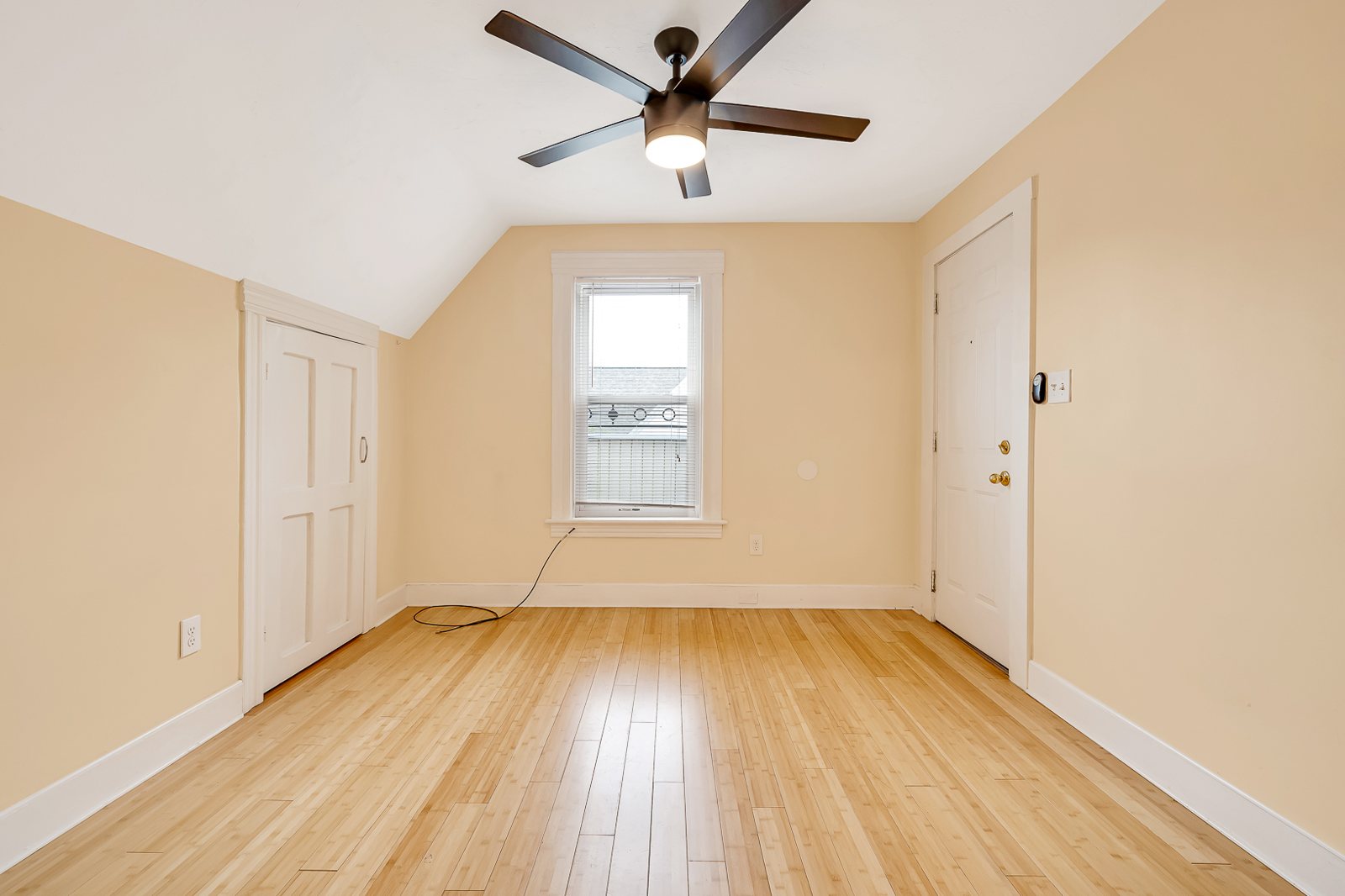 54 Sever St — bright bedroom with ceiling fan and hardwood